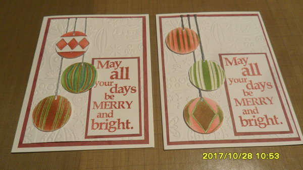 I used an ornament embossing folder and cut out stenciled ornaments with silver floss for hanging.