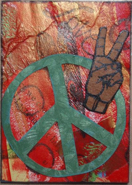 paper fabric background, stamped over, cut out peace sign from dry embossed paper, hand peace sign on cardboard